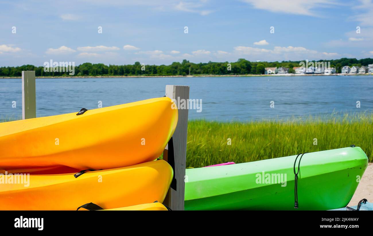 Kayaks near waters edge in summer time with copy space Stock Photo