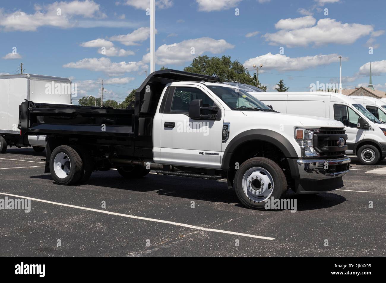 Indianapolis - Circa July 2022: Ford F-450 Dump Truck display at a dealership. The F450 is available in Chassis Cab, and Flatbed models. Stock Photo