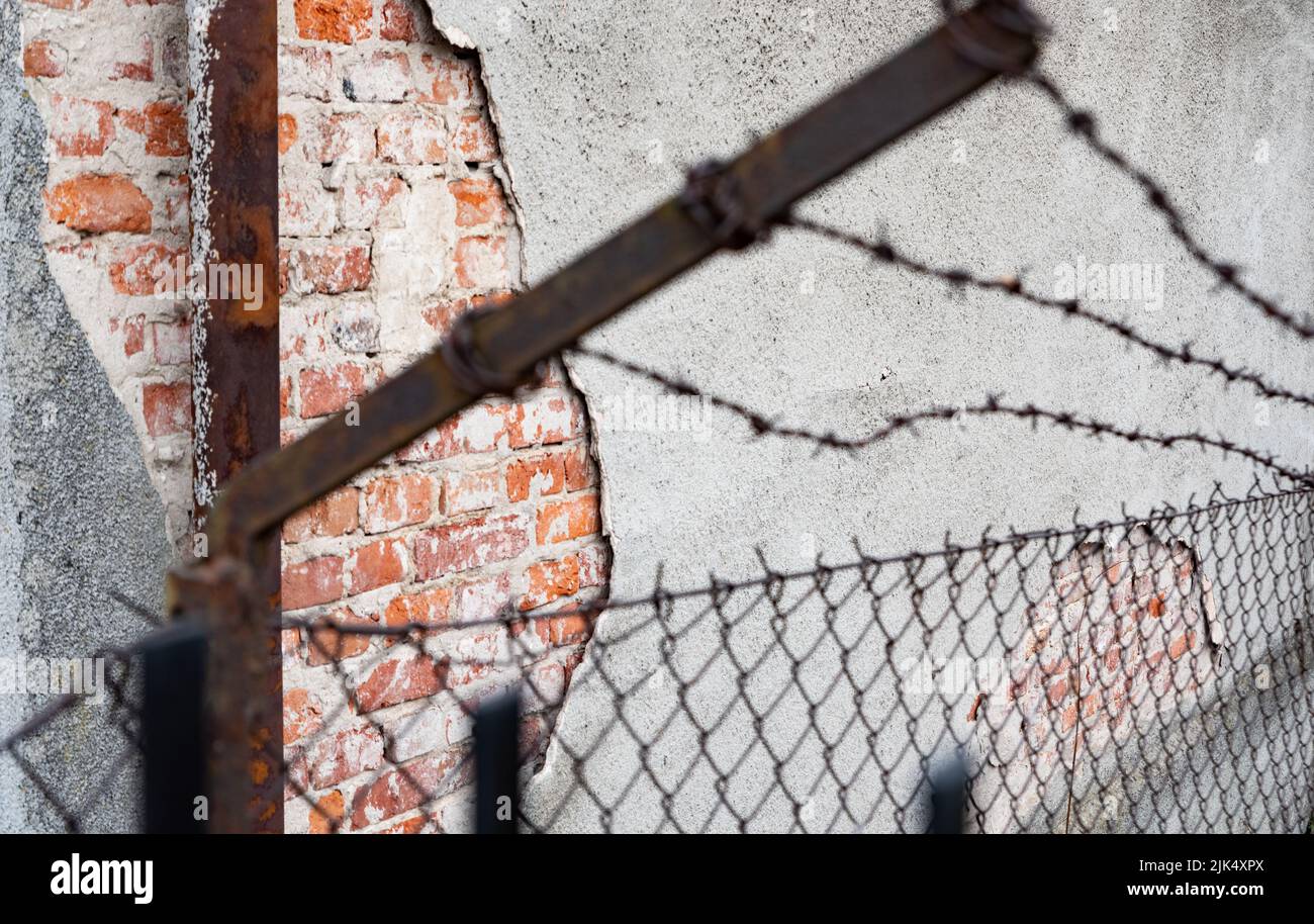 Old barbed wire fence. Rusty barbed wire on a brick wall background ...