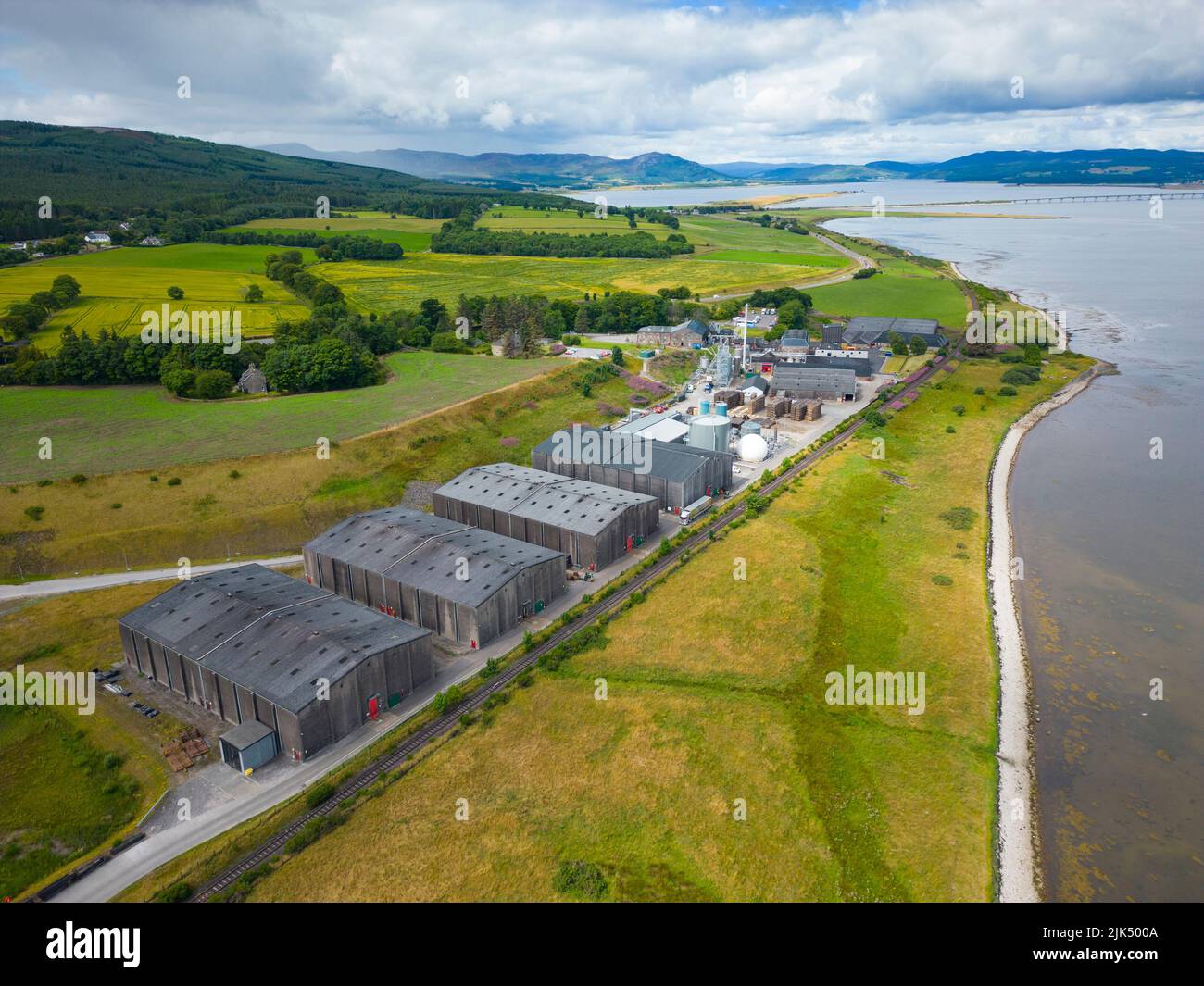 The Glenmorangie distillery branding on the orange wall of the visitor  centre in Tain Stock Photo - Alamy