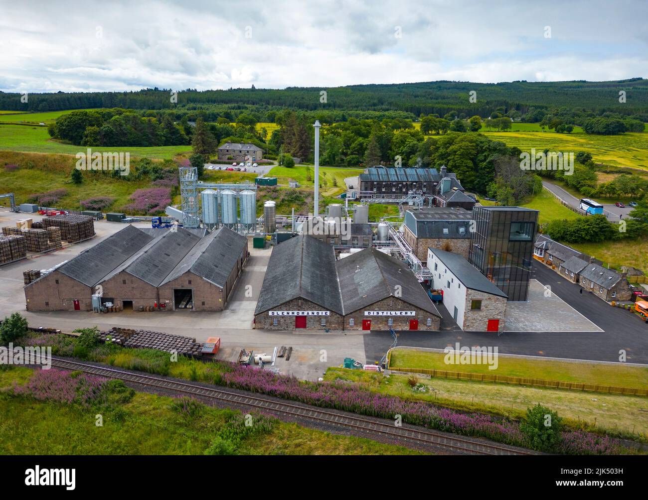 The Glenmorangie distillery branding on the orange wall of the visitor  centre in Tain Stock Photo - Alamy