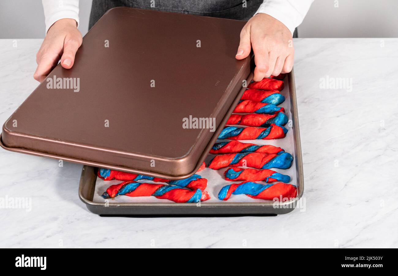 Rising patriotic cinnamon twists on the baking sheet lined with