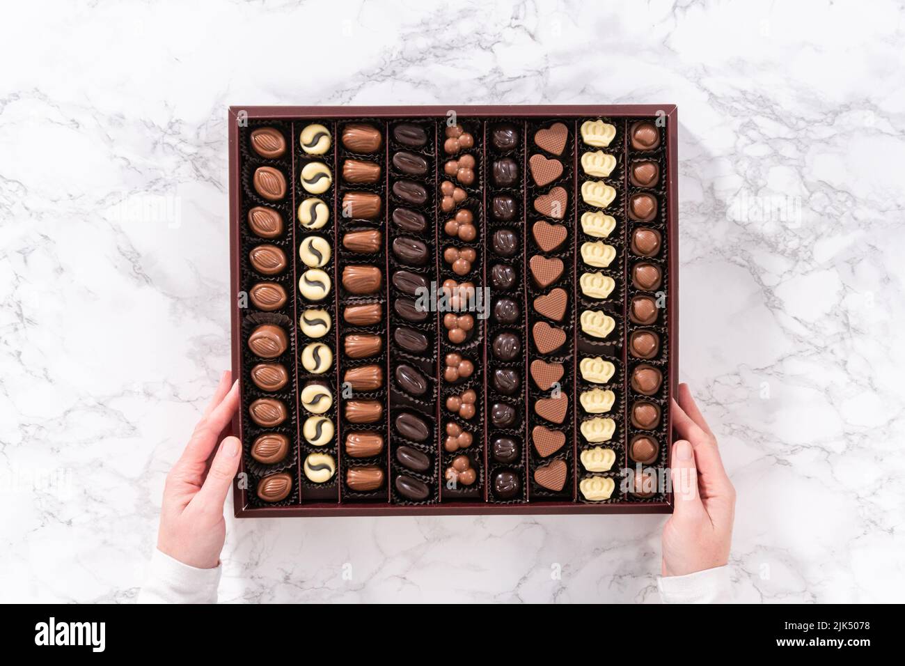 Flat lay. Box of gourmet assorted chocolates ina large box Stock Photo ...
