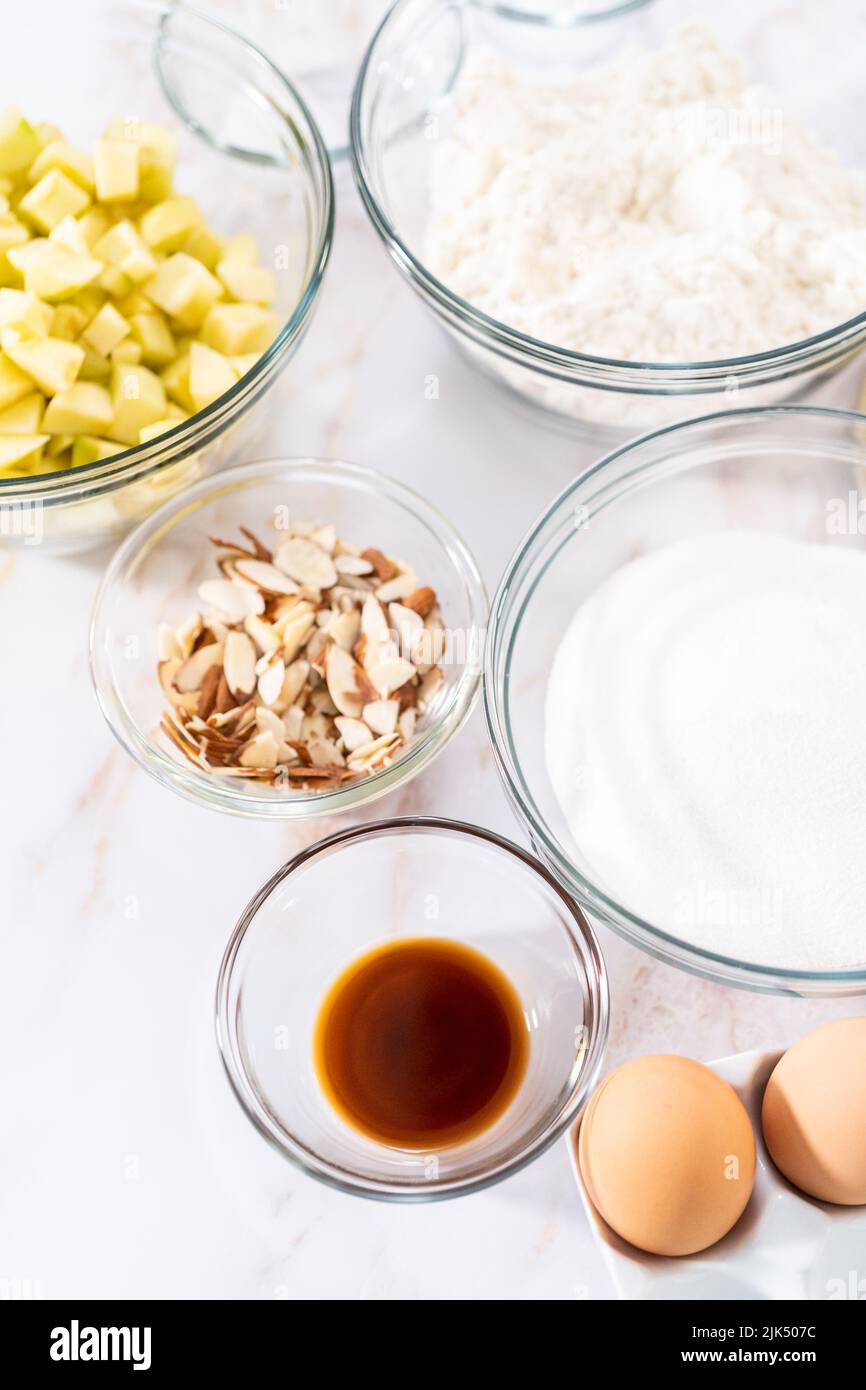 Measured ingredients in a glass mixing bowl to bake Apple bundt cake