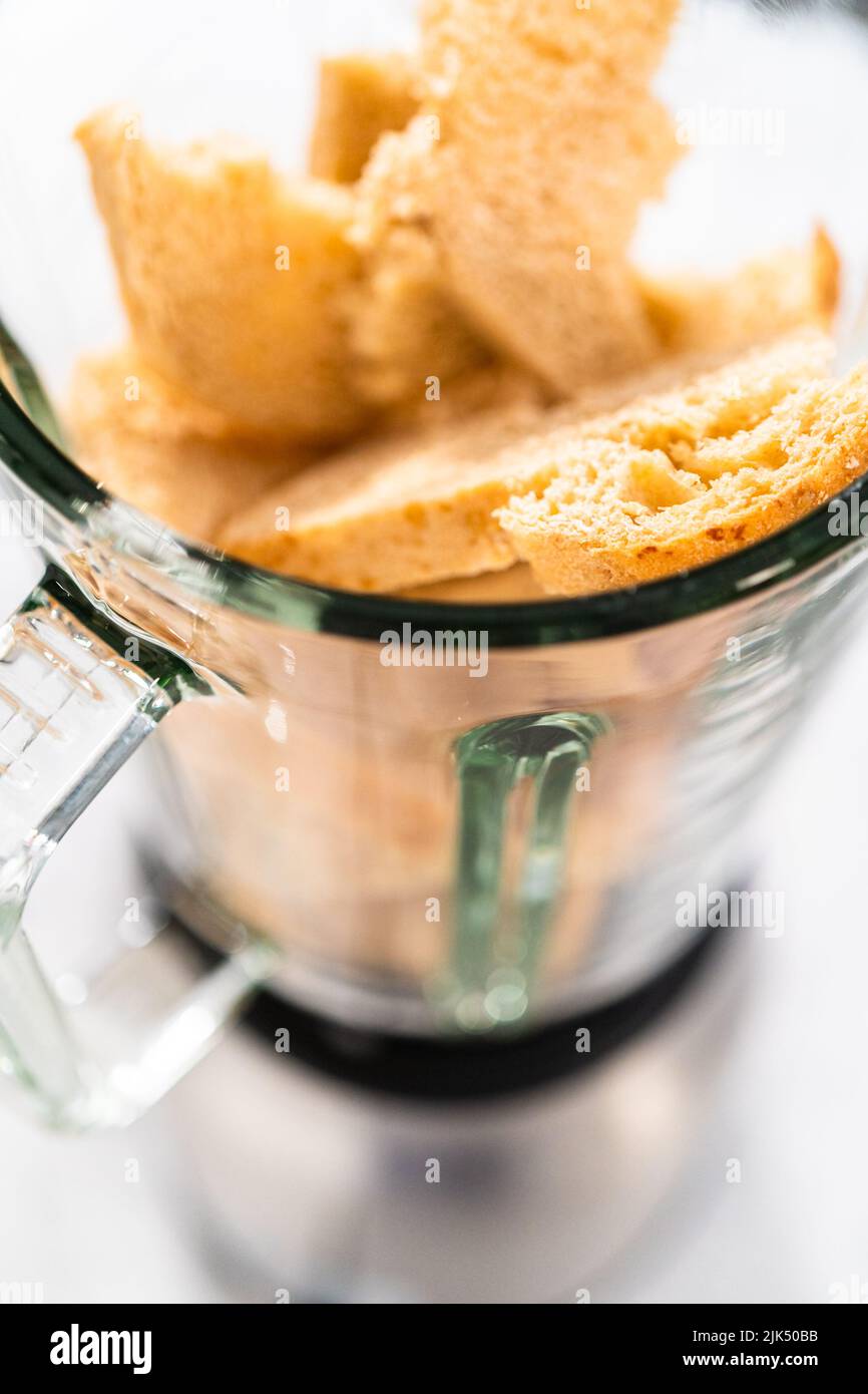 Blending stale bread in a blender to make bread crumbs Stock Photo Alamy