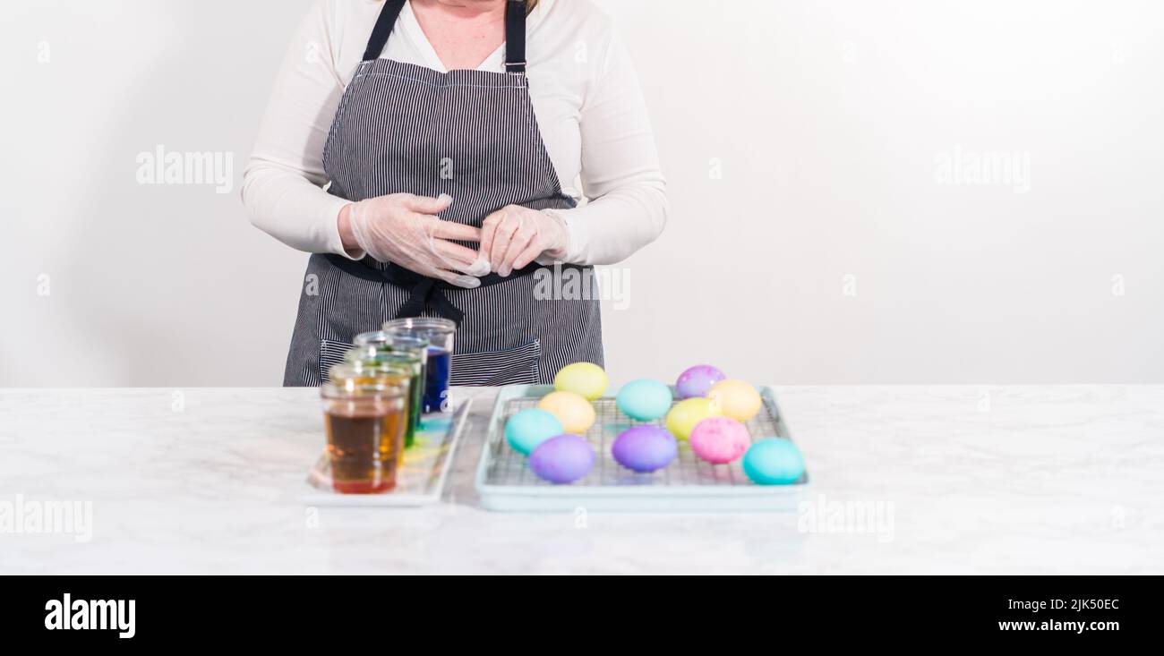 Easter egg coloring. Dye white organic eggs in different colors for