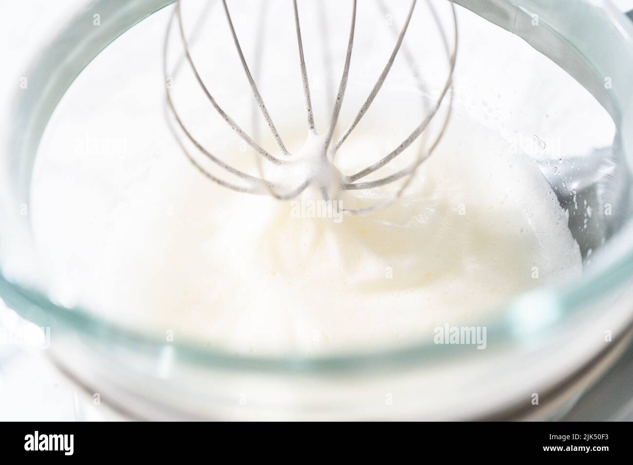 Whipping egg whites in a stand electric mixer to bake meringue cookies Stock Photo Alamy