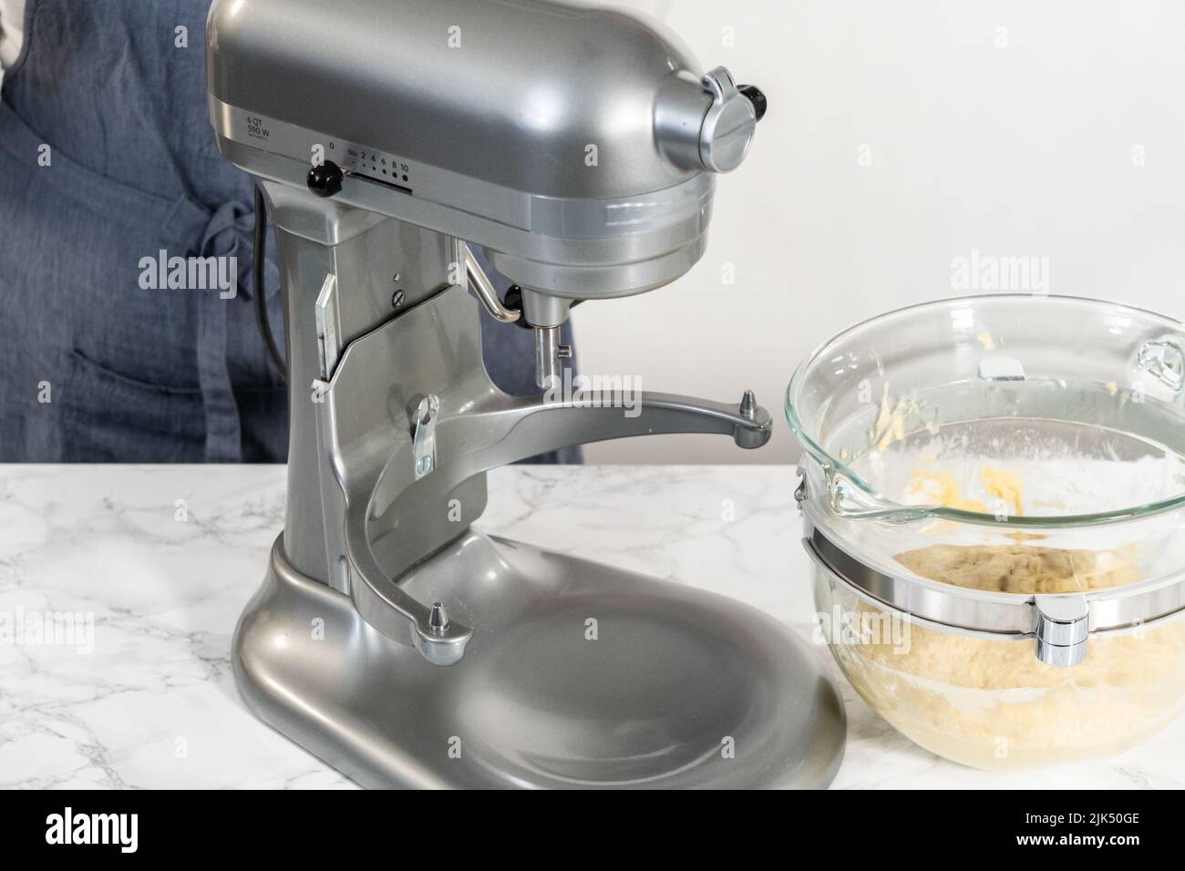 Mixing ingredients in kitchen mixer to bake mini Easter bread kulich