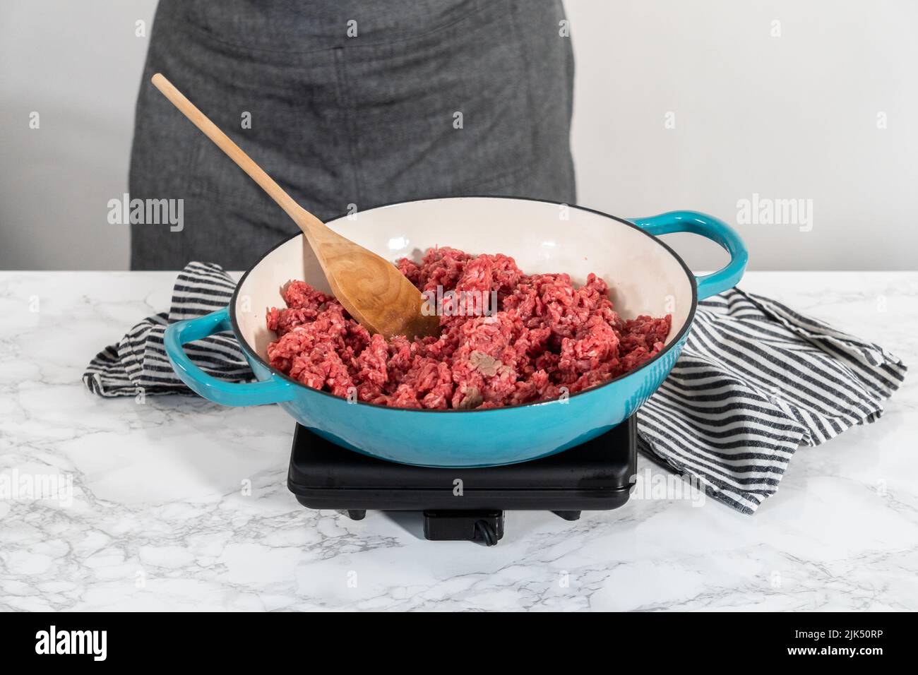 Browning ground beef in cast iron skillet to make homemade hamburger