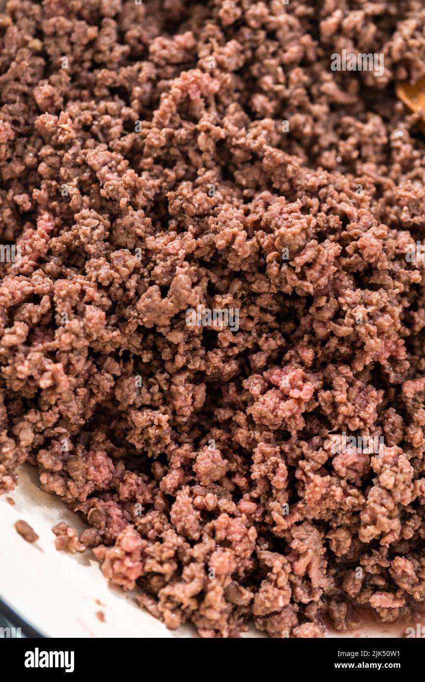 Browning ground beef in cast iron skillet to make homemade hamburger