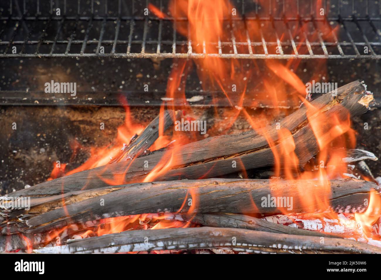 The preparation of fire for the BBQ in flame of burning charcoal logs