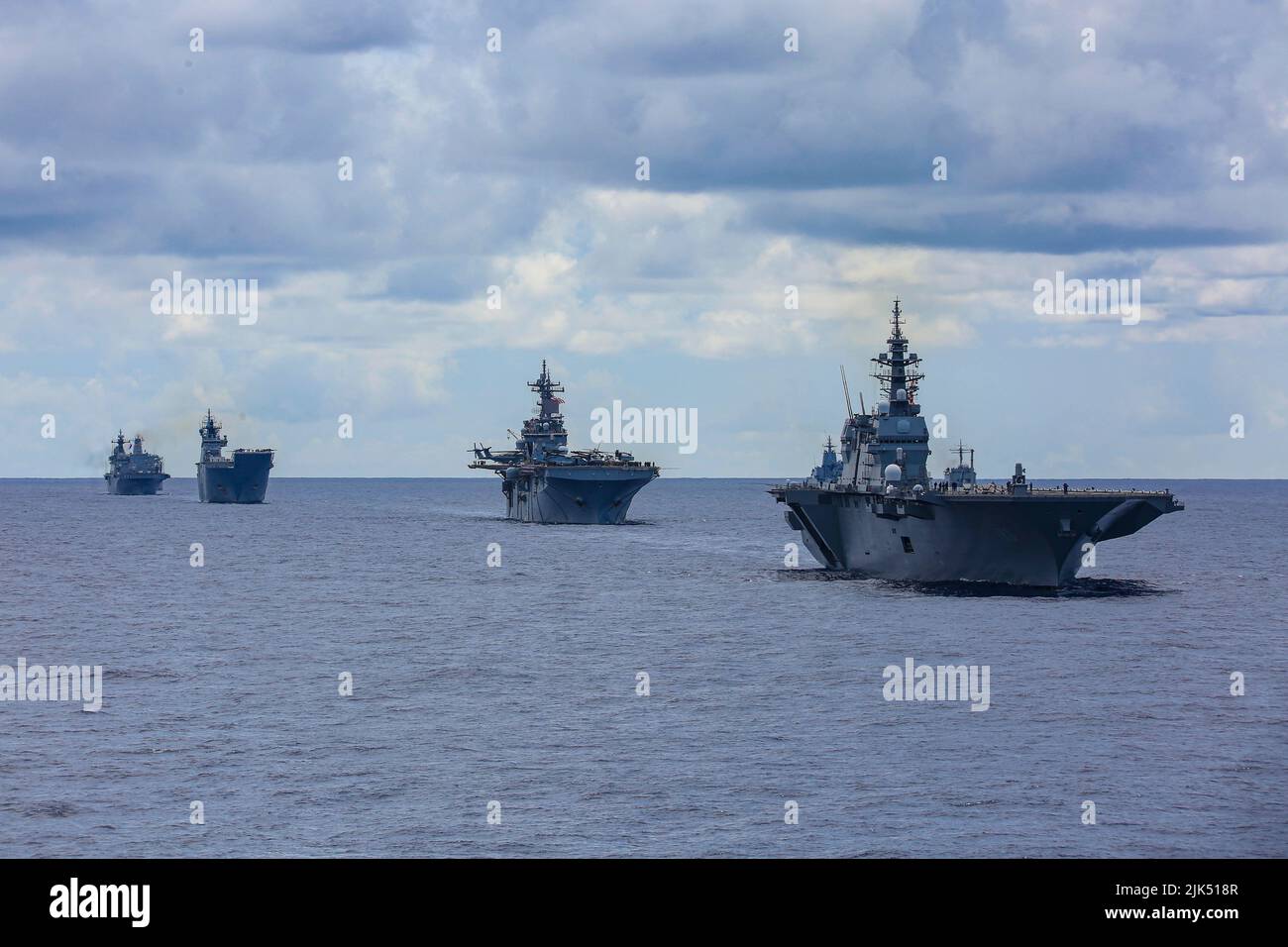 220728-N-VI910-3045 PACIFIC OCEAN (July 28, 2022) Japan Maritime Self-Defense Force helicopter carrier JS Izumo (DDH 183), right, sails in formation in front of Wasp-class amphibious assault ship USS Essex (LHD 2), Royal Australian Navy landing helicopter dock HMAS Canberra (L02) and Republic of Korea Navy amphibious assault ship ROKS Marado (LPH 6112) during Rim of the Pacific (RIMPAC) 2022, July 28. Twenty-six nations, 38 ships, three submarines, more than 30 unmanned systems, approximately 170 aircraft and 25,000 personnel are participating in RIMPAC from June 29 to Aug. 4 in and around the Stock Photo