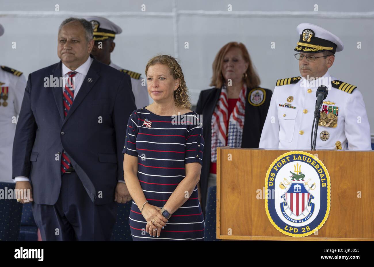 Fort Lauderdale, Florida, USA. 30th July, 2022. (L-R) Secretary of the Navy the Honorable Carlos Del Toro, U.S. Rep. Debbie Wasserman Schultz (FL-23) and Commanding Officer, Capt. James Quaresimo stand during the National Anthem at the commissioning ceremony for the USS Fort Lauderdale (LPD 28), Port Everglades, Florida.The USS Fort Lauderdale (LPC28) is a San Antonio-class amphibious transport dock ship. Credit: UPI/Alamy Live News Stock Photo