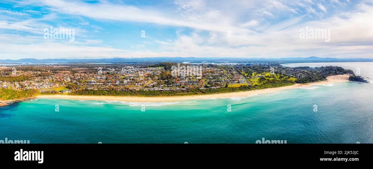 Arc of aerial panorama facing One Mile beach in Forster town of Australia from Pacific ocean. Stock Photo