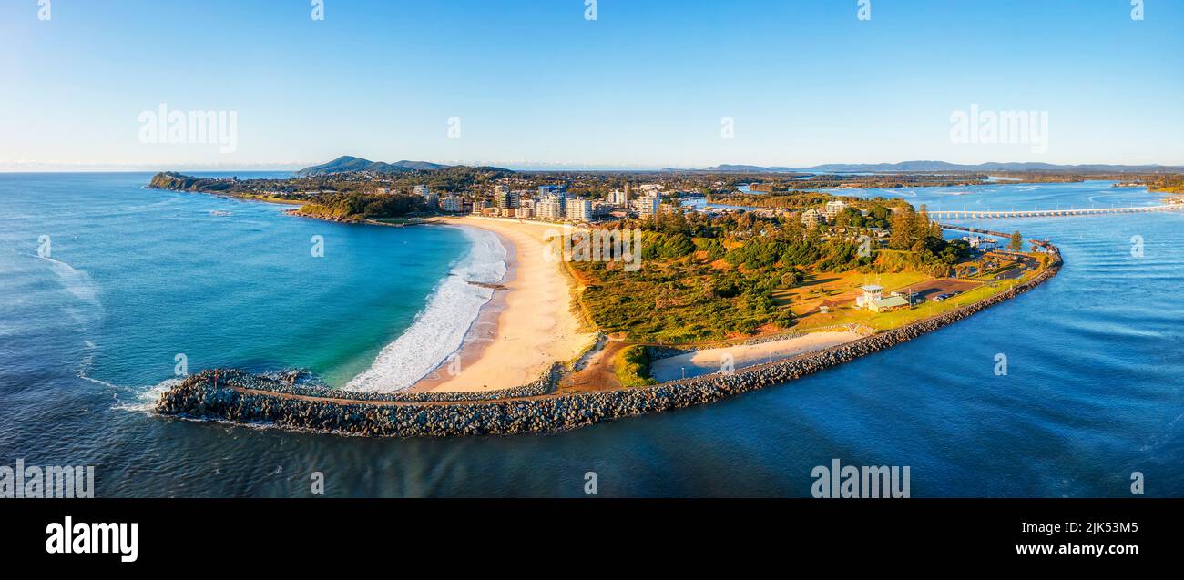 Breakwater at river mouth on Pacific coast of Australia at Forster town - short aerial panorama. Stock Photo