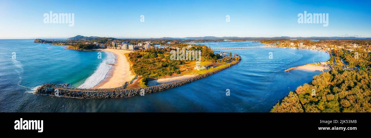 Breakwater at river mouth on Pacific coast of Australia at Forster town - aerial panorama. Stock Photo