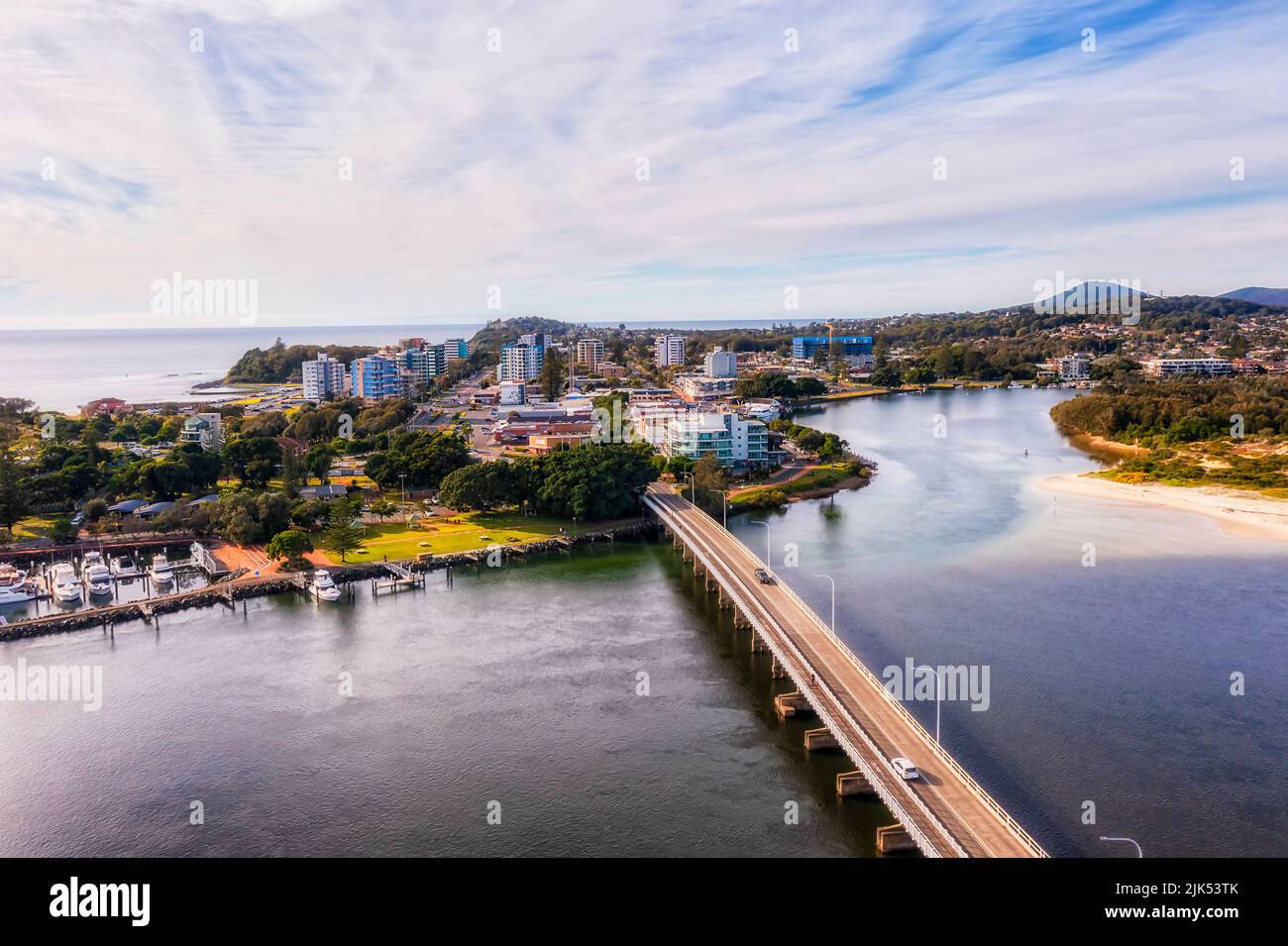 Downtown main streets in Forster town on Pacific coast of Australia from bridge across Wallis lake - aerial view. Stock Photo