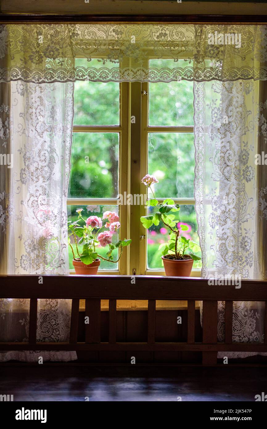 a bouquet of flowers in the window of a beautiful building Stock Photo