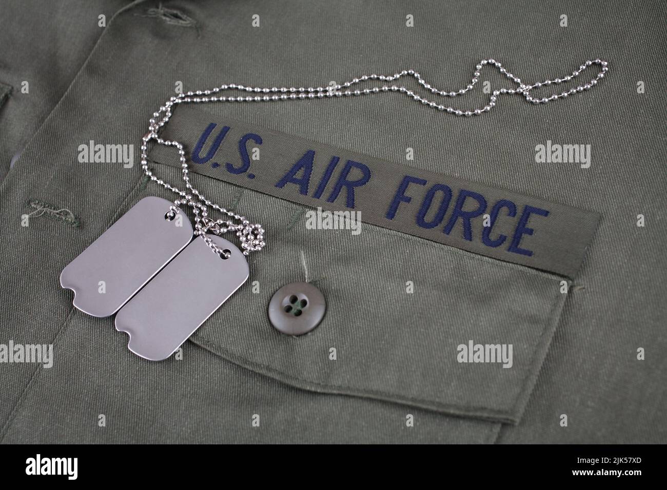 U.S. AIR FORCE Branch Tape with dog tags on olive drab uniform background Stock Photo