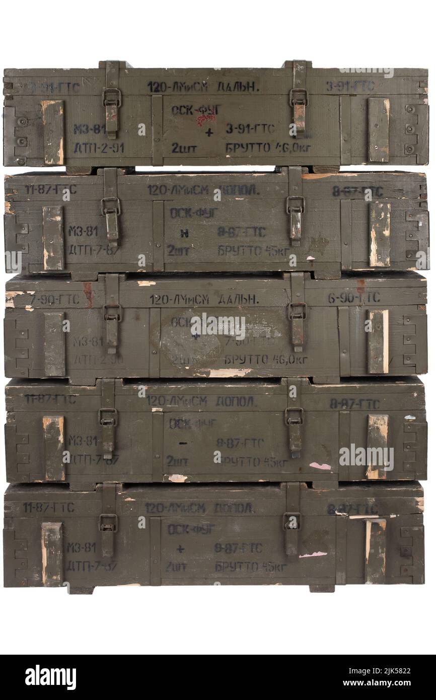 Soviet army ammunition stack of green crates. Text in russian - type of ammunition, projectile caliber, projectile type, number of pieces and weight. Stock Photo
