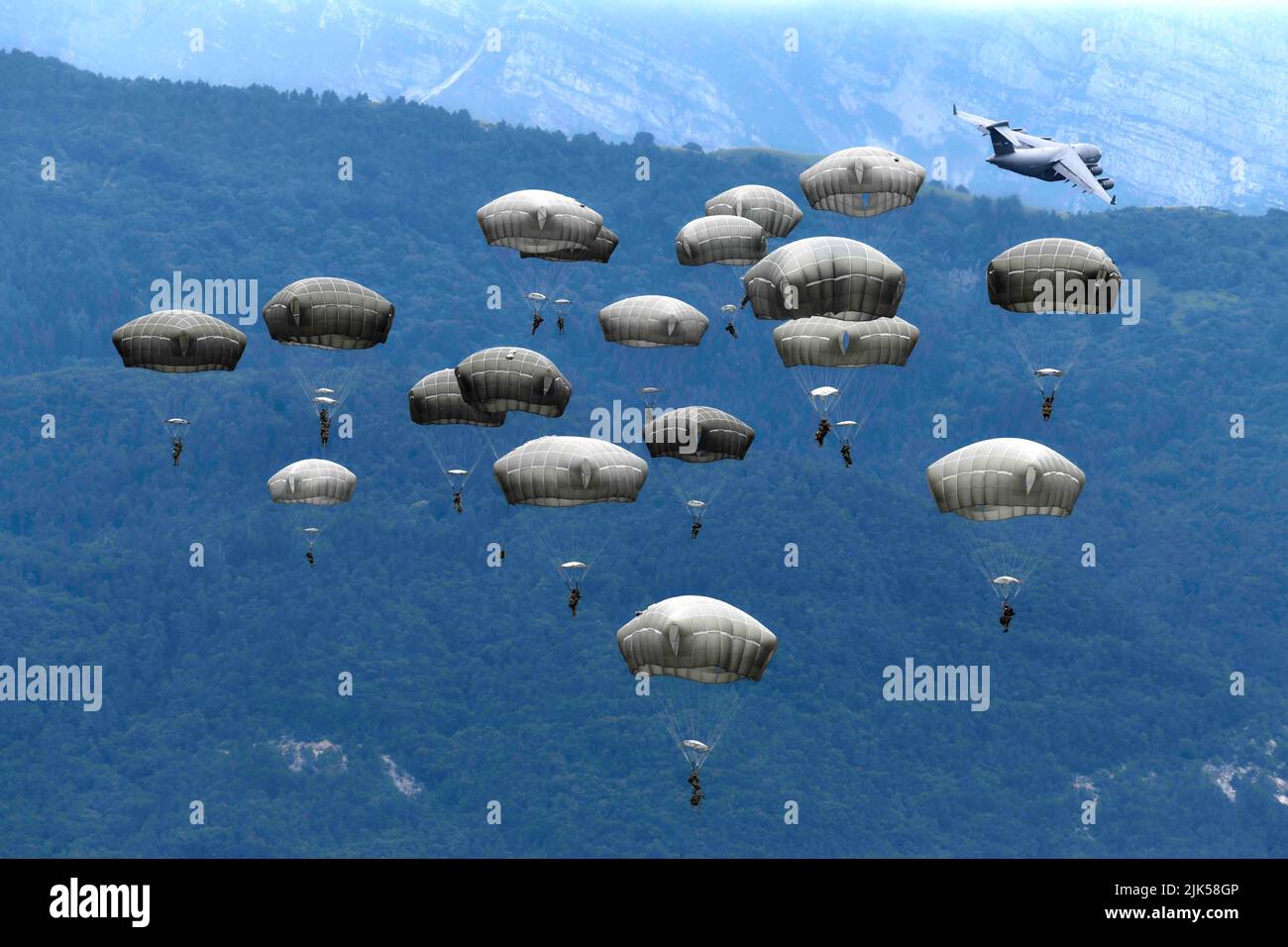 July 7, 2022 - Pordenone, Italy - U.S. Army paratroopers assigned to the 1st Battalion, 503rd Parachute Infantry Regiment, 173rd Airborne Brigade, Italian Army paratroopers assigned to 4th Alpini Regiment, Folgore Brigade and Italian Army assigned to Command of the Army Special Forces (COMFOSE), conduct an airborne operation from a C17 Globemaster III Aircraft from Papa Air Base Hungary onto Julyiet Drop Zone in Pordenone, Italy on July 7, 2022. The 173rd Airborne Brigade is the U.S. Army Contingency Response Force in Europe, capable of projecting ready forces anywhere in the U.S. European, Af Stock Photo