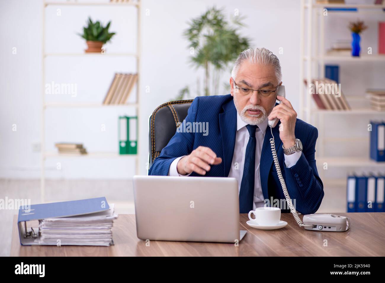 Old businessman employee working at workplace Stock Photo - Alamy