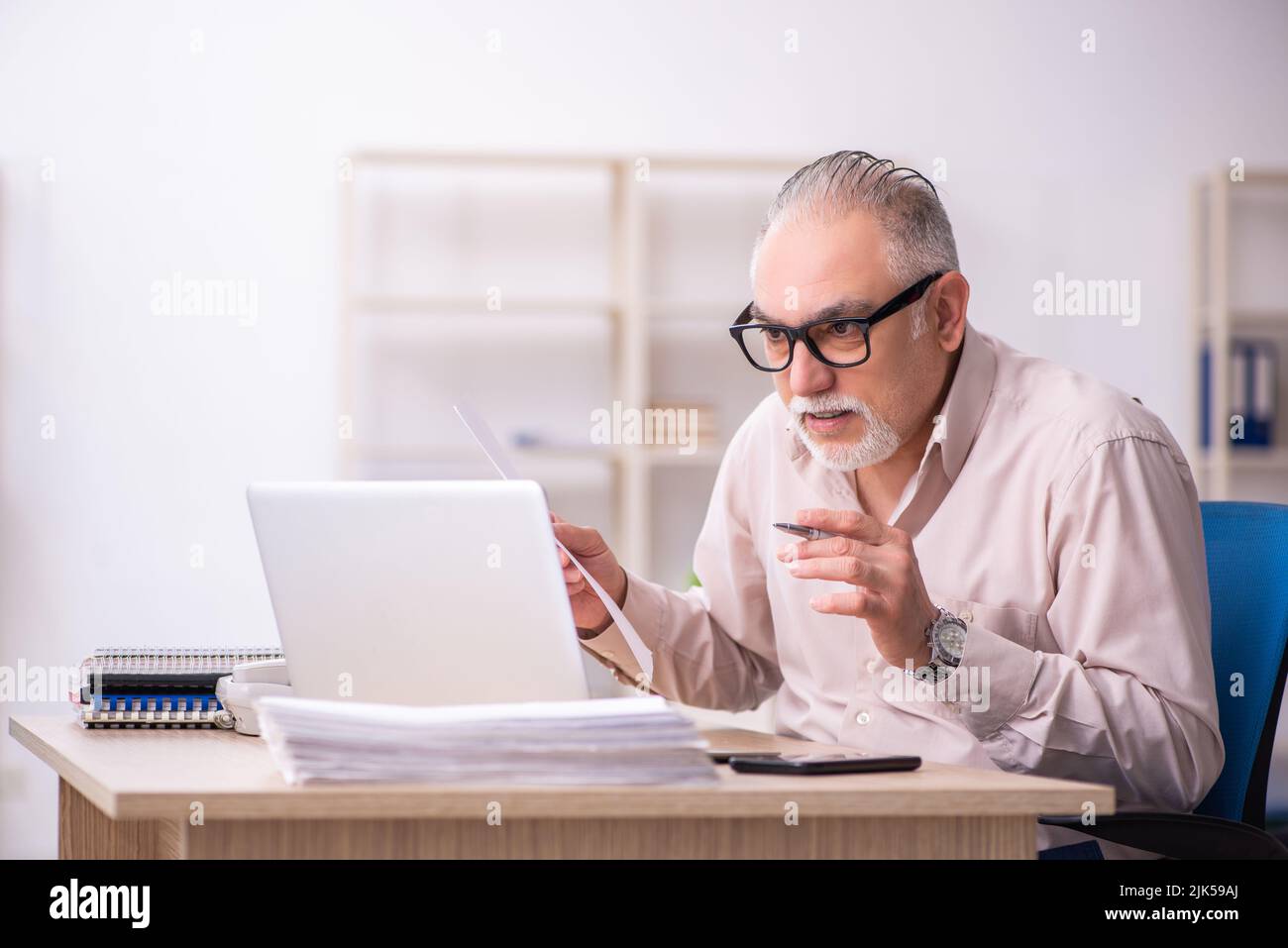 Old businessman employee working at workplace Stock Photo - Alamy