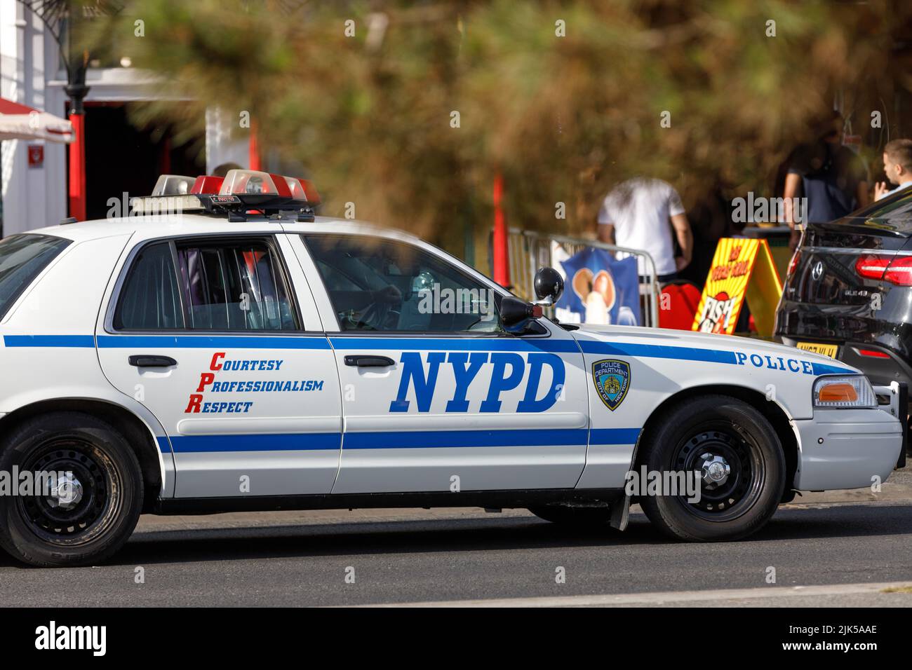 A vintage NYPD Ford Crown Victoria sedan car driving on an English street. New York Police Department vehicle in the UK Stock Photo