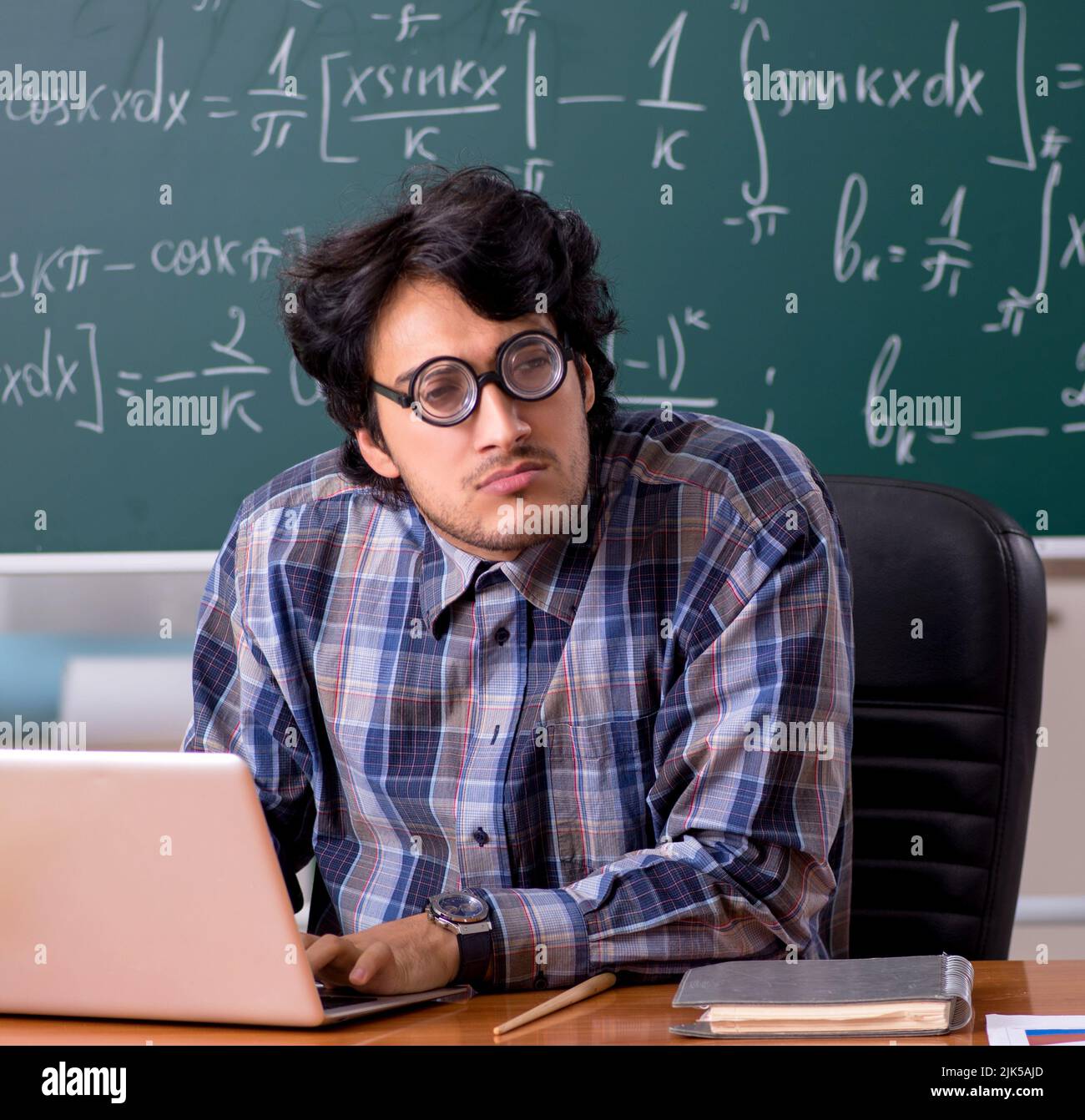 The funny male math teacher in the classroom Stock Photo - Alamy
