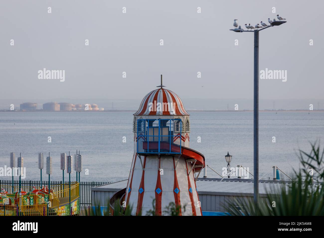 The Helter Skelter Lighthouse Slip at Adventure Island, Southend with Grain LNG terminal Kent in the background, across the River Thames Stock Photo