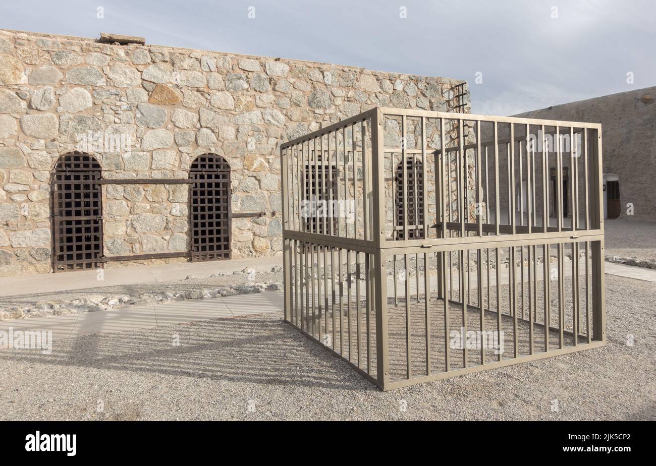 Old Iron Prison Cell Bars and Stone Wall in Courtyard of Famous Yuma Territorial Prison Arizona USA State Historic Park Stock Photo