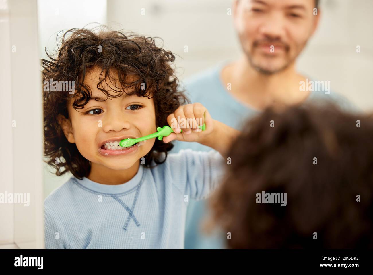 My dad taught me well. a father teaching his son how to brush teeth at home Stock Photo Alamy