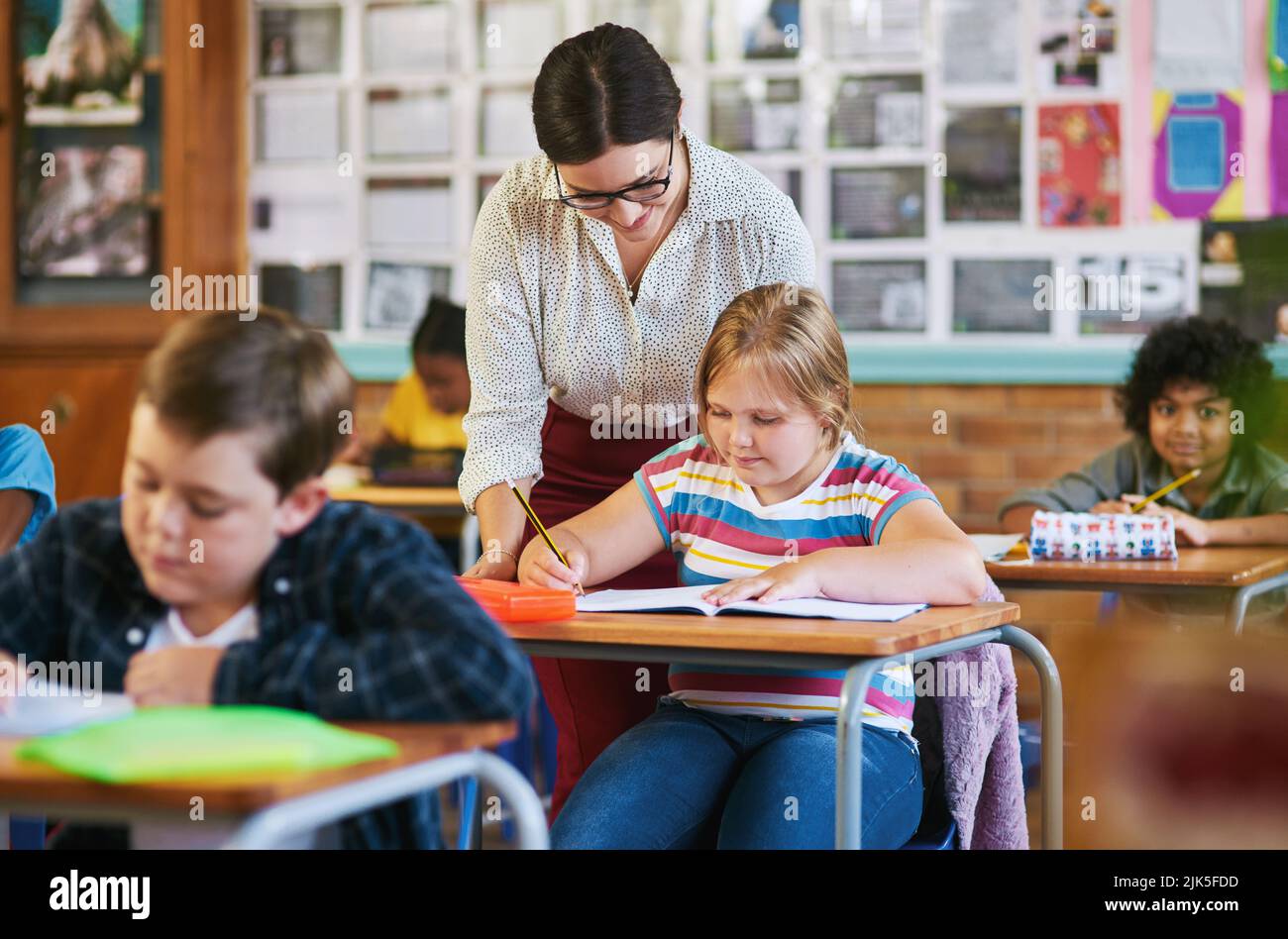 What are they asking you to find. an attractive young teacher helping a