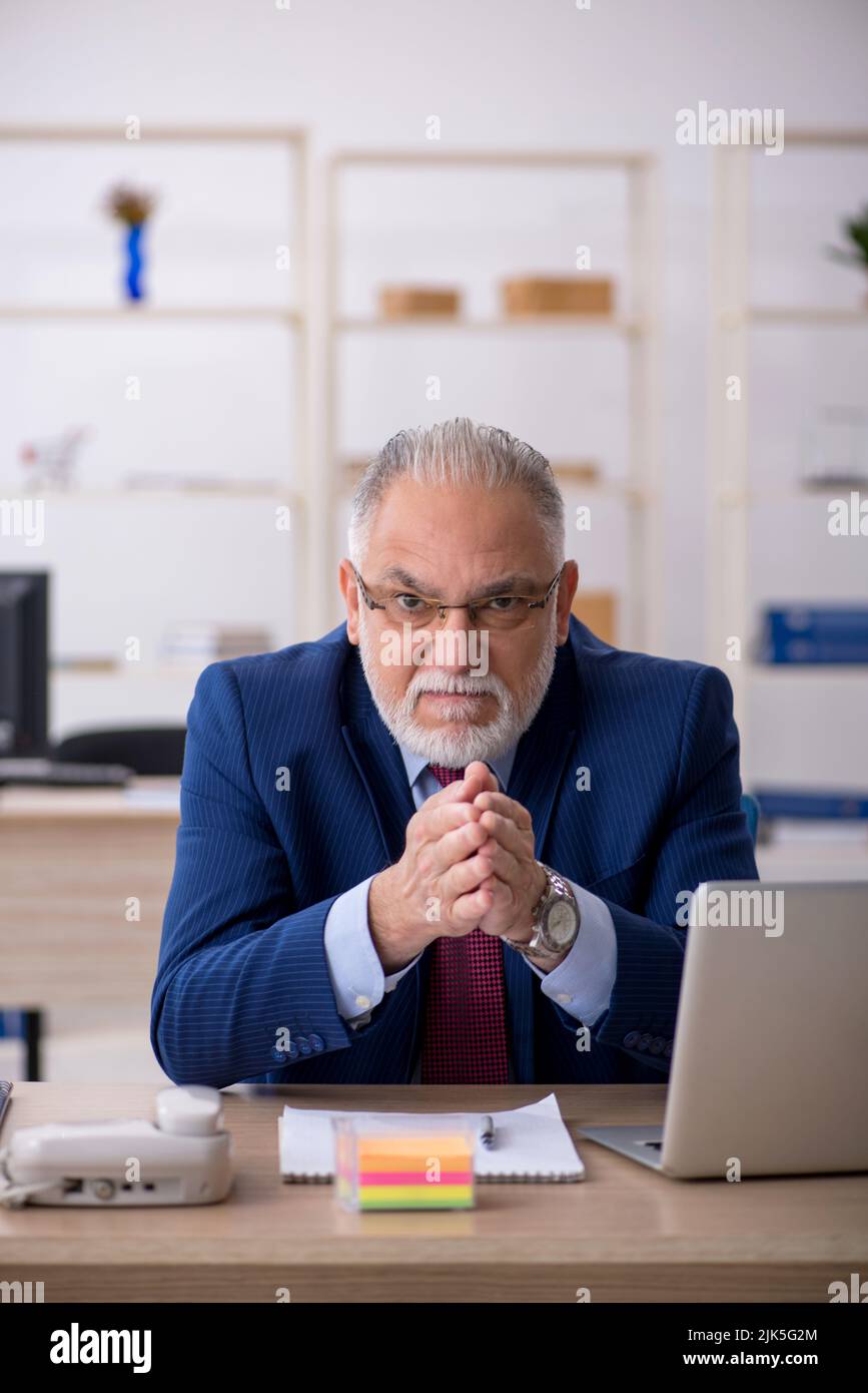 Old businessman employee working at workplace Stock Photo - Alamy