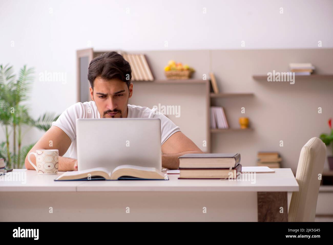 Young student studying at home during pandemic Stock Photo - Alamy