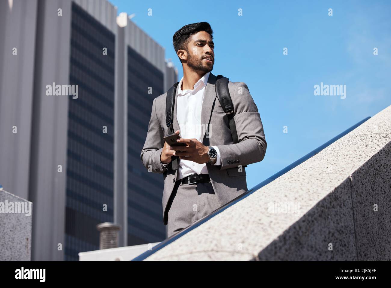 Stay focused on the future. a young businessman using a phone in the city. Stock Photo