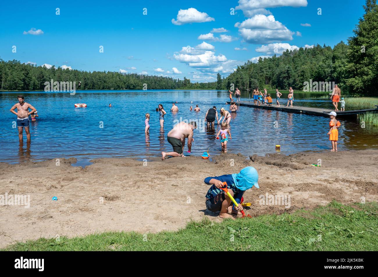 Lake Sörsjön in the countryside outside Norrköping on a sunny summer day. Bathing in lakes is a popular leisure activity in Sweden during summer. Stock Photo