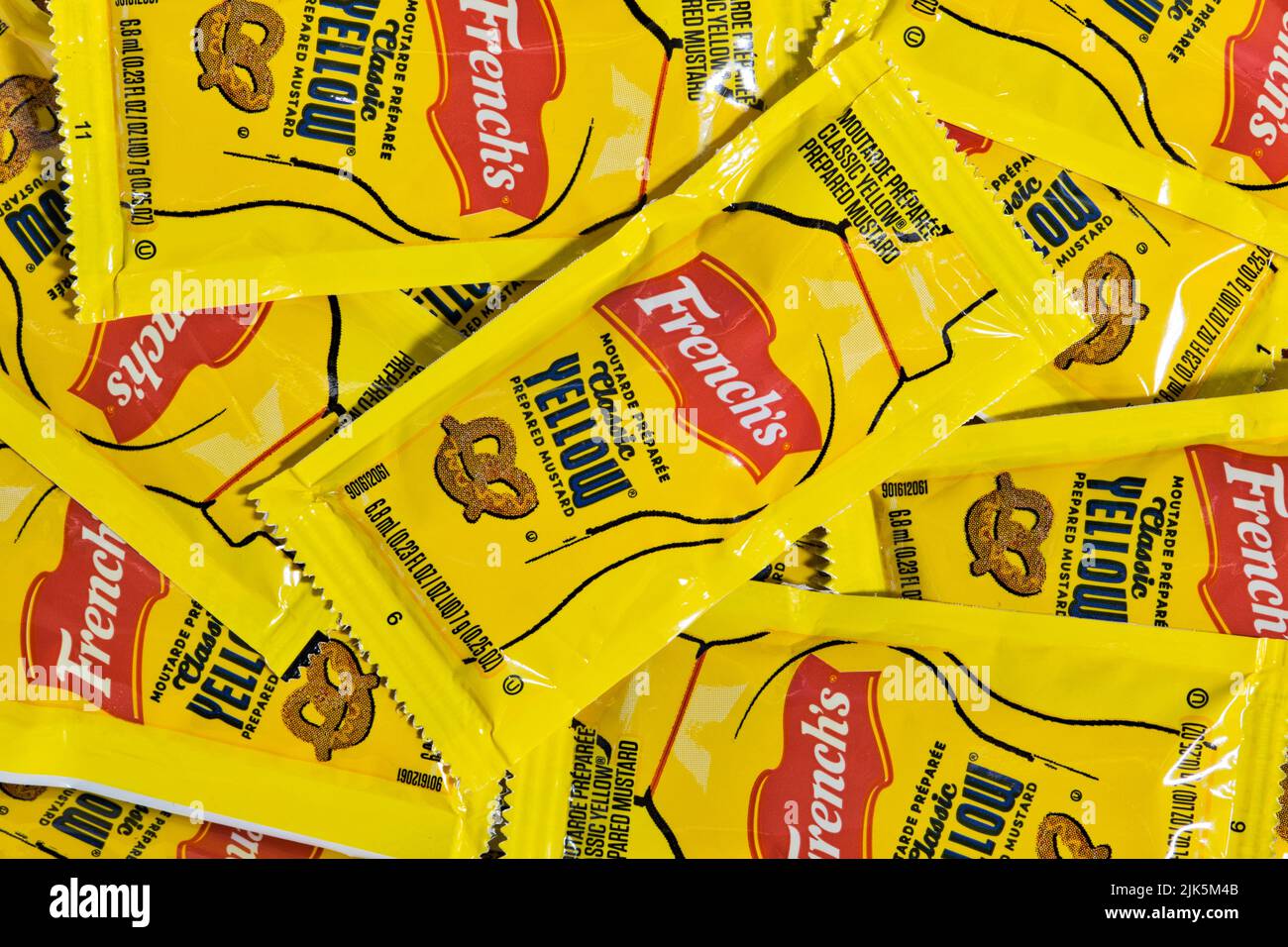 Houston, Texas USA 07-14-2022: French's Yellow Mustard sachets scattered loosely showing brand name and logo. American condiment owned by McCormick. Stock Photo