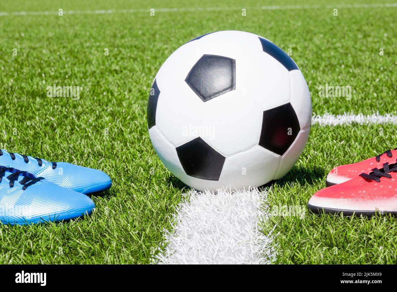 Soccer football background. Soccer ball and two pair of football sports