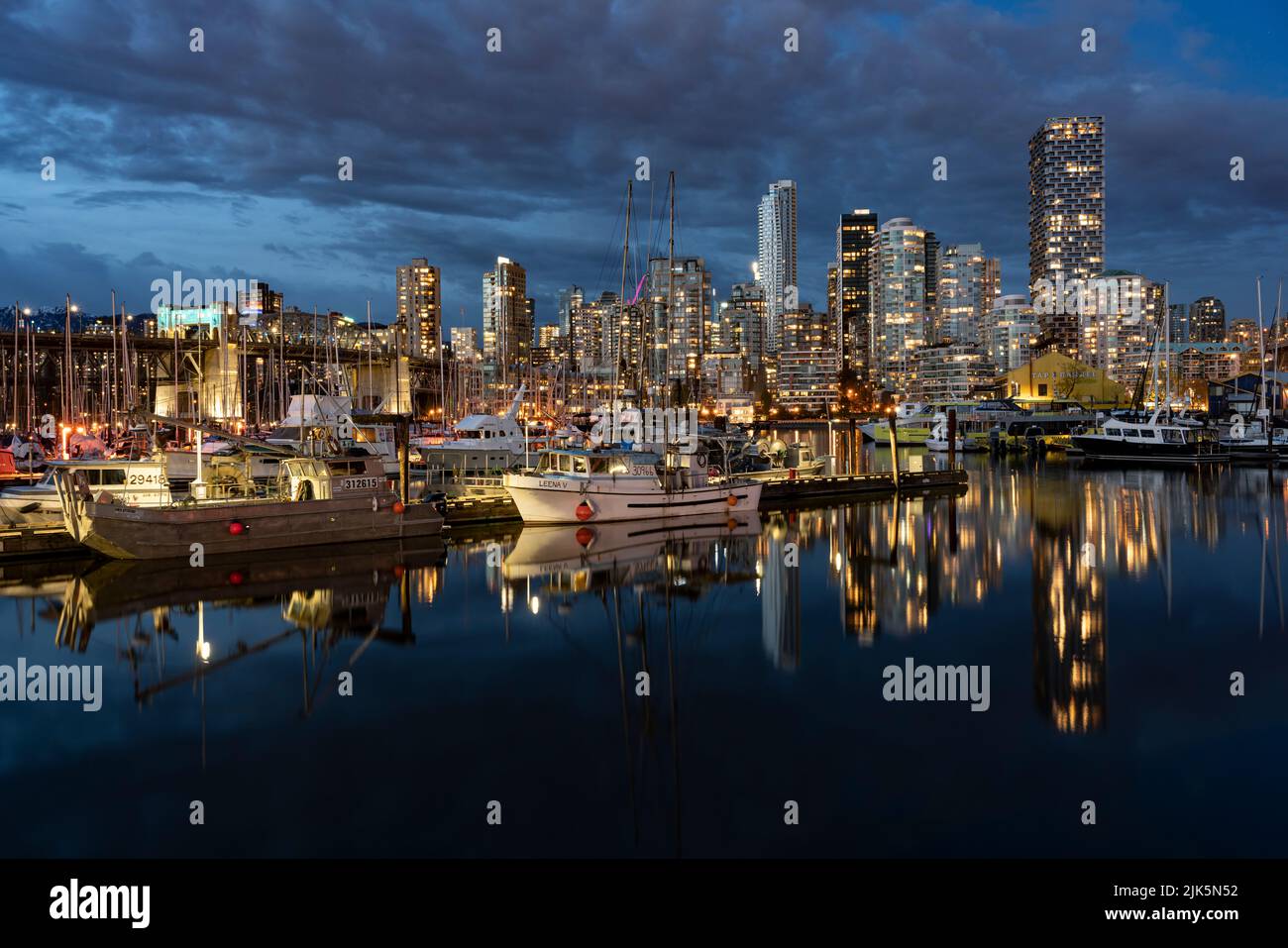 False Creek with reflections of boats and buildings at night, in Vancouver, British Columbia, Canada. Stock Photo