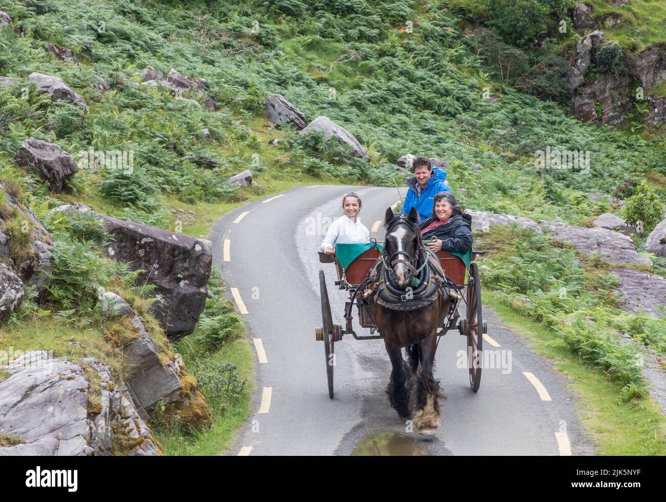 Gap of Dunloe, Killarney, Ireland. 30th July, 2022. Visitors Claudia and Beth Di Falco from Oregon with Jarvey Tom Johnson take a trip through the Gap of Dunloe, Killarney, Co. Kerry, Ireland. - Credit; David Creedon / Alamy Live News Stock Photo