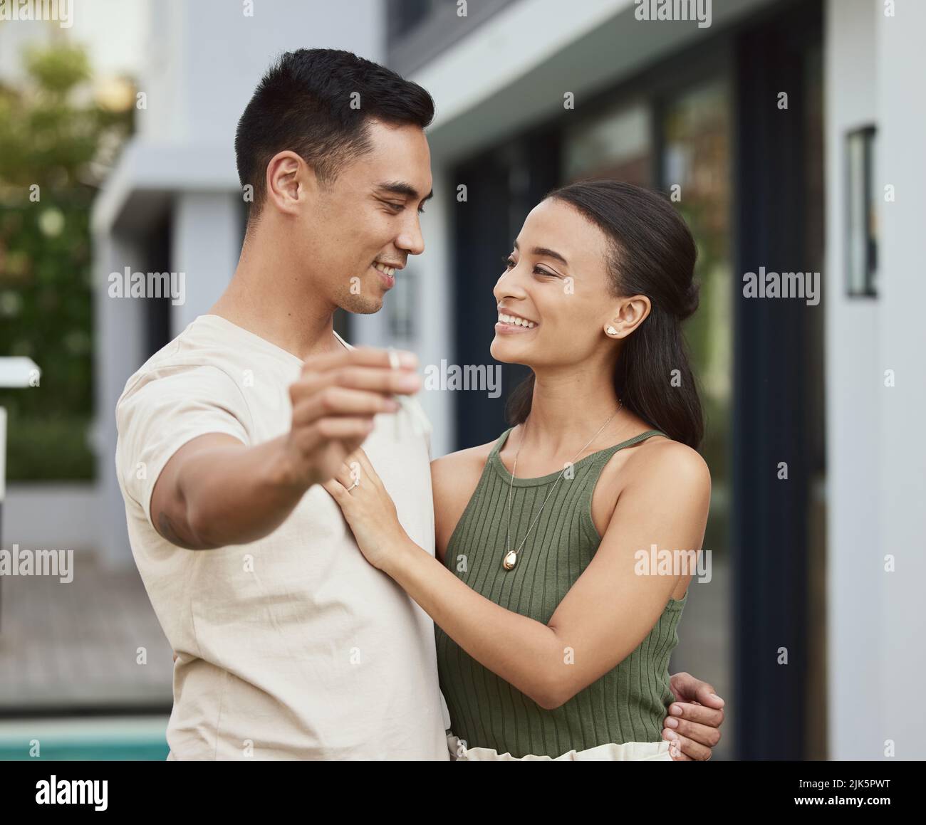 We liked it so we bought it. a young couple holding the key to their ...