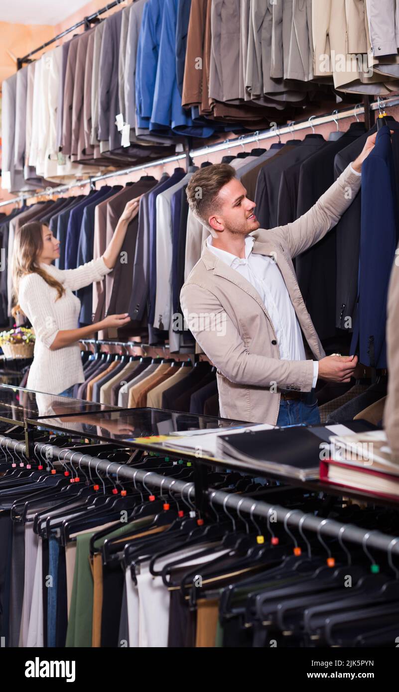 couple choosing new suit in men’s cloths store Stock Photo - Alamy
