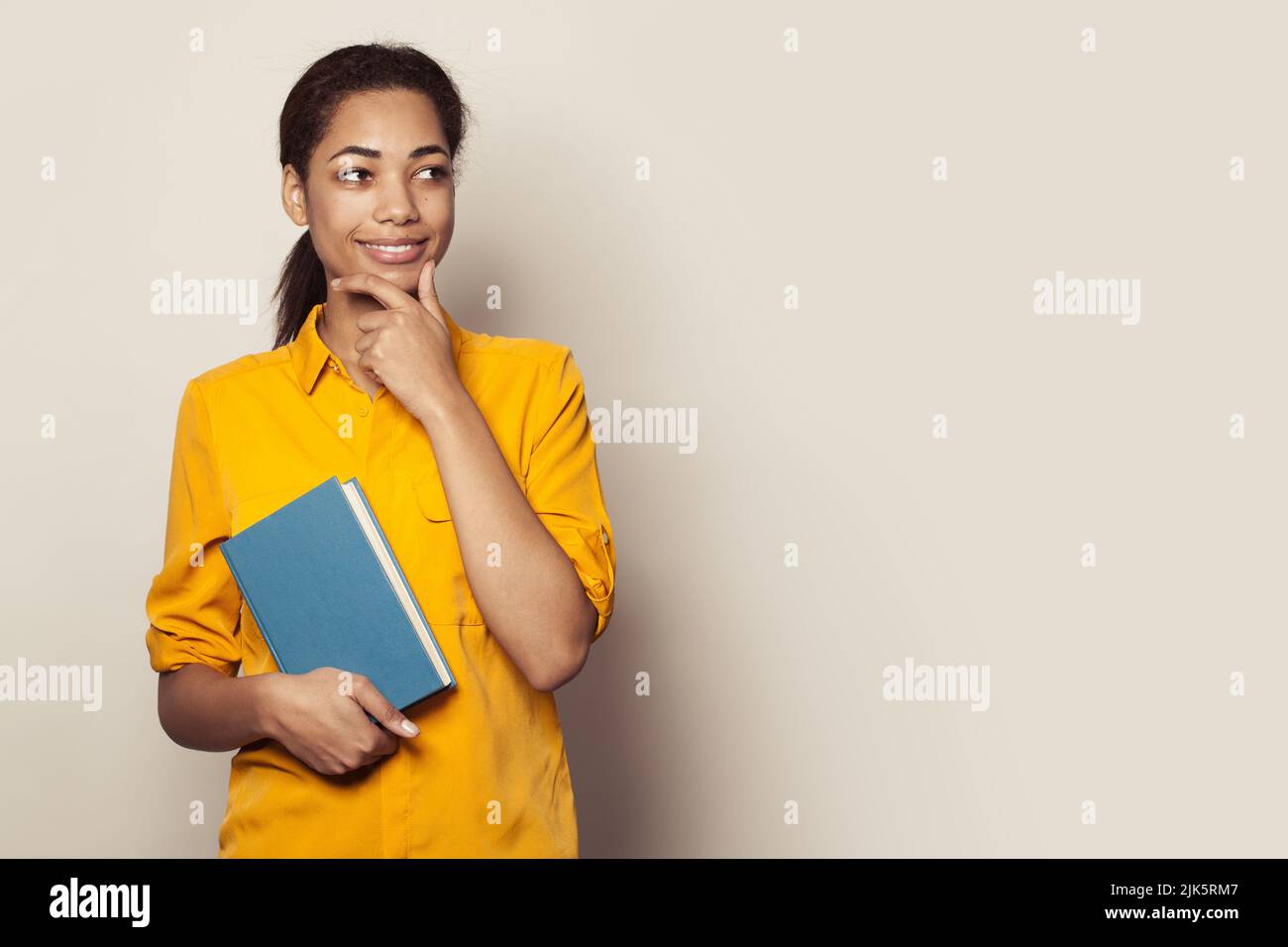 Woman wearing yellow shirt hi-res stock photography and images - Alamy