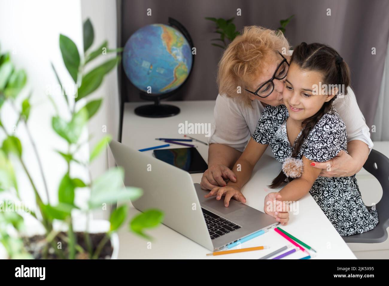 little girl with her grandmother using laptop Stock Photo - Alamy