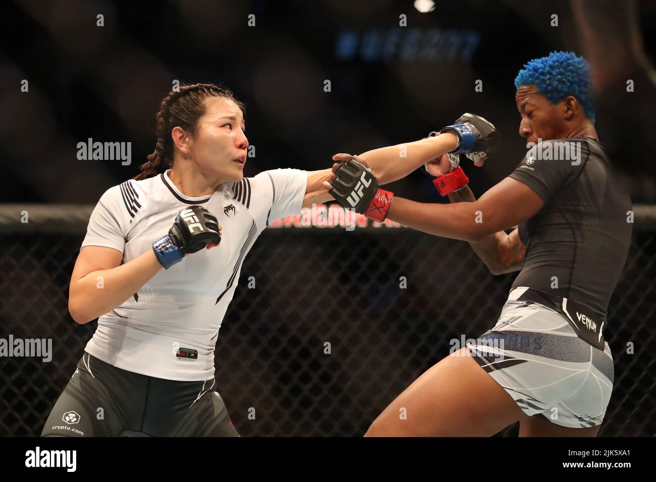 DALLAS, TX - JULY 30: (L-R) Ji Yeon Kim punches Joselyne Edwards in their Women’s Bantamweight bout during the UFC 277 event at American Airlines Center on July 30, 2022, in Dallas, Texas, United States. (Photo by Alejandro Salazar/PxImages) Credit: Px Images/Alamy Live News Stock Photo