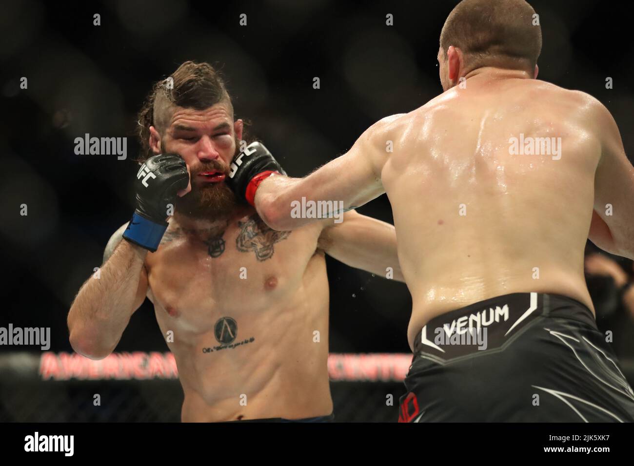 DALLAS, TX - JULY 30: (R-L) Alex Morono punches Matthew Semelsberger in their Welterweight bout during the UFC 277 event at American Airlines Center on July 30, 2022, in Dallas, Texas, United States. (Photo by Alejandro Salazar/PxImages) Credit: Px Images/Alamy Live News Stock Photo