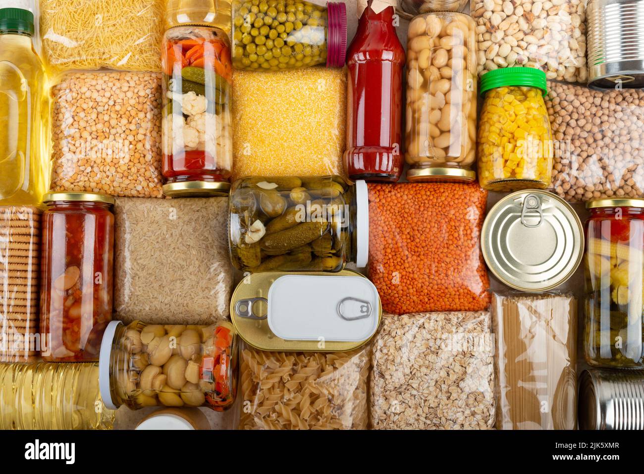 Emergency survival groceries on kitchen table closeup flat lay Stock Photo