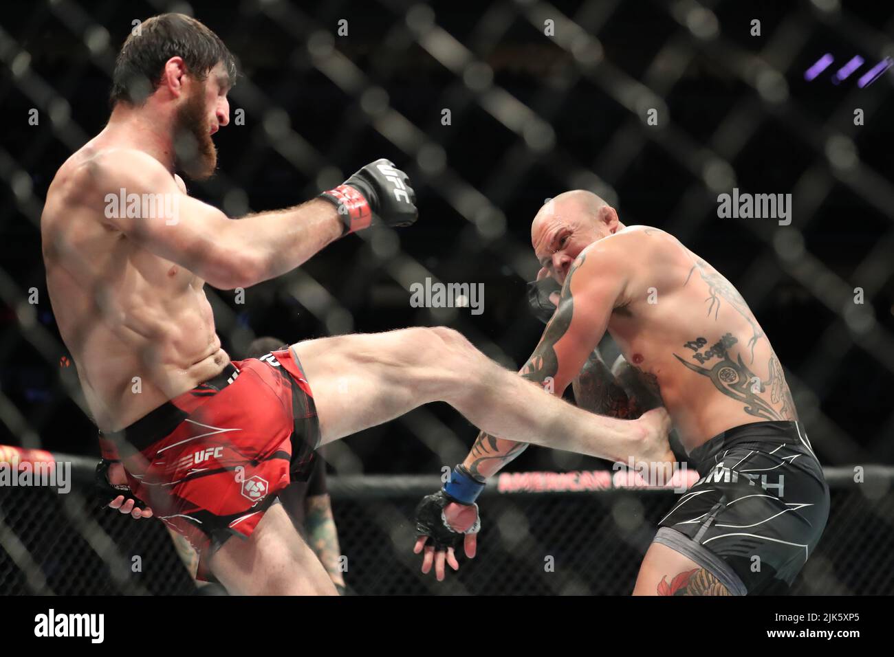 DALLAS, TX - JULY 30: (L-R) Magomed Ankalaev kicks Anthony Smith in their Light Heavyweight bout during the UFC 277 event at American Airlines Center on July 30, 2022, in Dallas, Texas, United States. (Photo by Alejandro Salazar/PxImages) Credit: Px Images/Alamy Live News Stock Photo