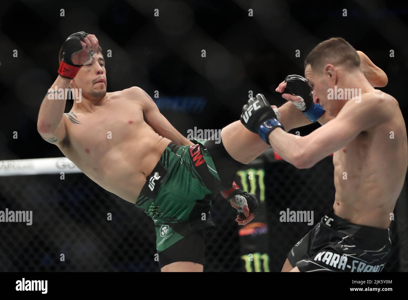 DALLAS, TX - JULY 30: (L-R) Brandon Moreno kicks Kai Kara-France in their Flyweight bout during the UFC 277 event at American Airlines Center on July 30, 2022, in Dallas, Texas, United States. (Photo by Alejandro Salazar/PxImages) Credit: Px Images/Alamy Live News Stock Photo